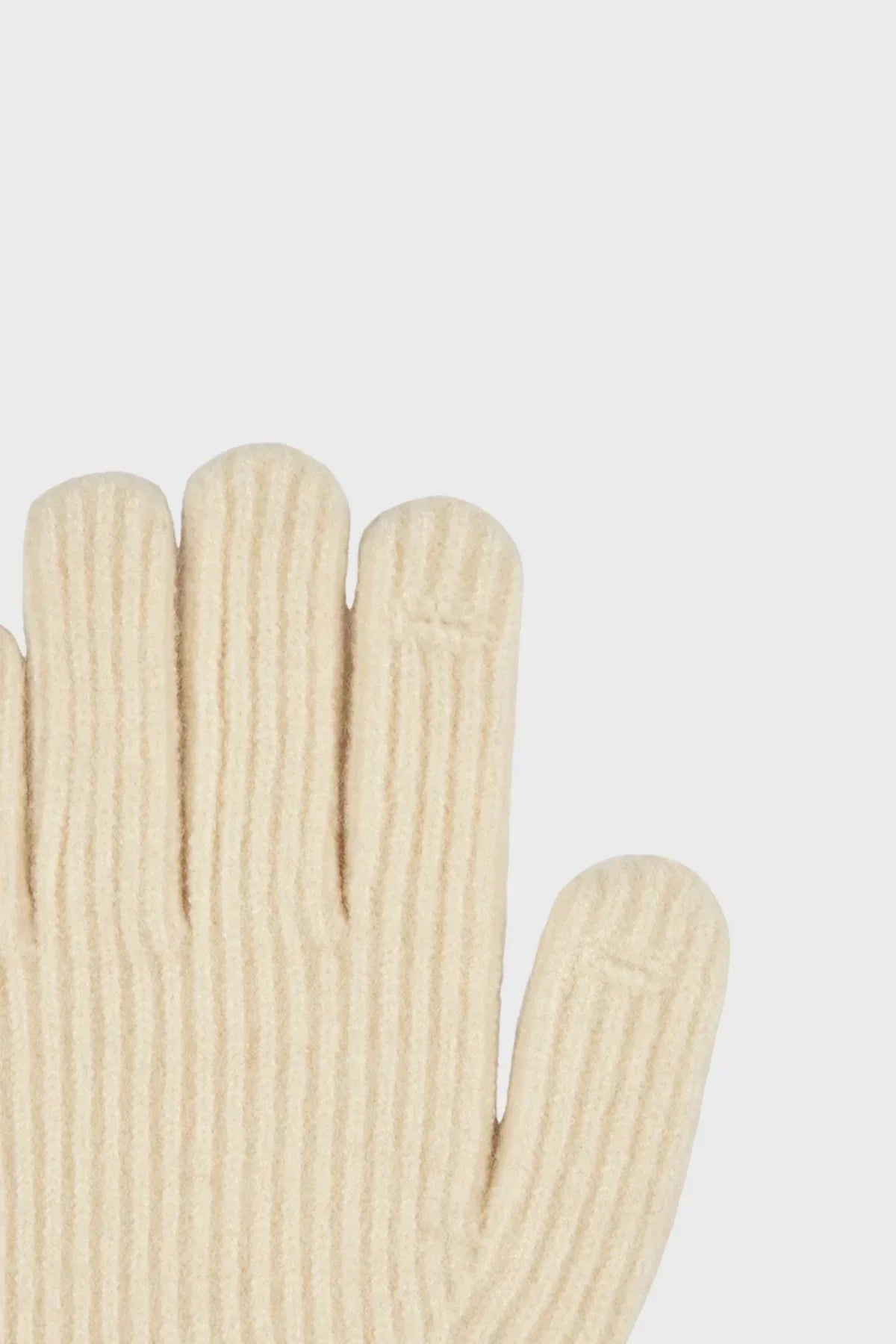 Close-up of cream-colored ribbed knit gloves with visible stitching details on fingers