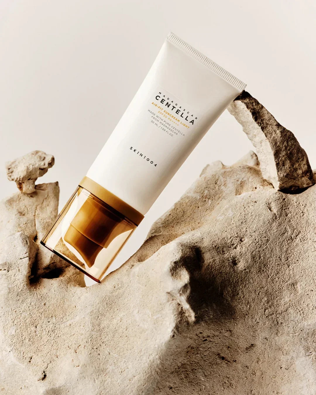 SKIN1004 Madagascar Centella Air-Fit Suncream Light SPF30 PA++ tube on textured beige rock background
