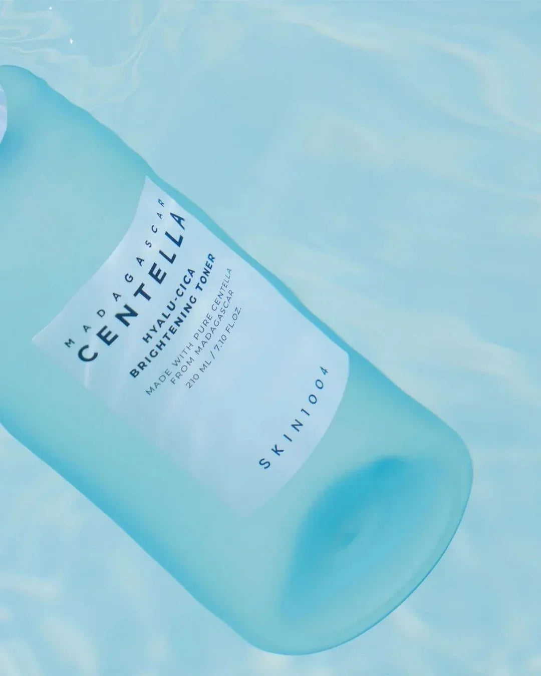 Madagascar Centella Hyalu-Cica Brightening Toner bottle floating in clear blue water