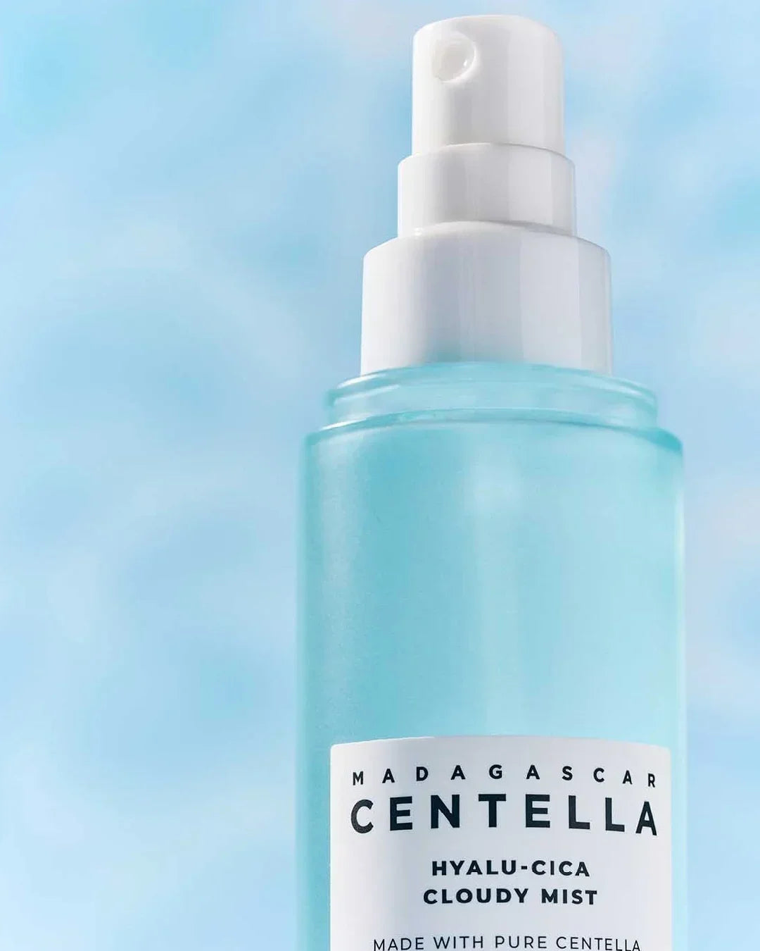 Madagascar Centella Hyalu-Cica Cloudy Mist spray bottle with white pump on blue background