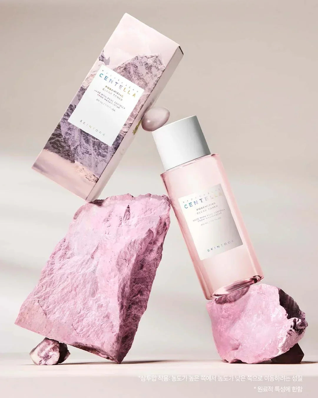 Madagascar Centella Poremizing Clear Toner 210ml with pastel pink packaging and stones