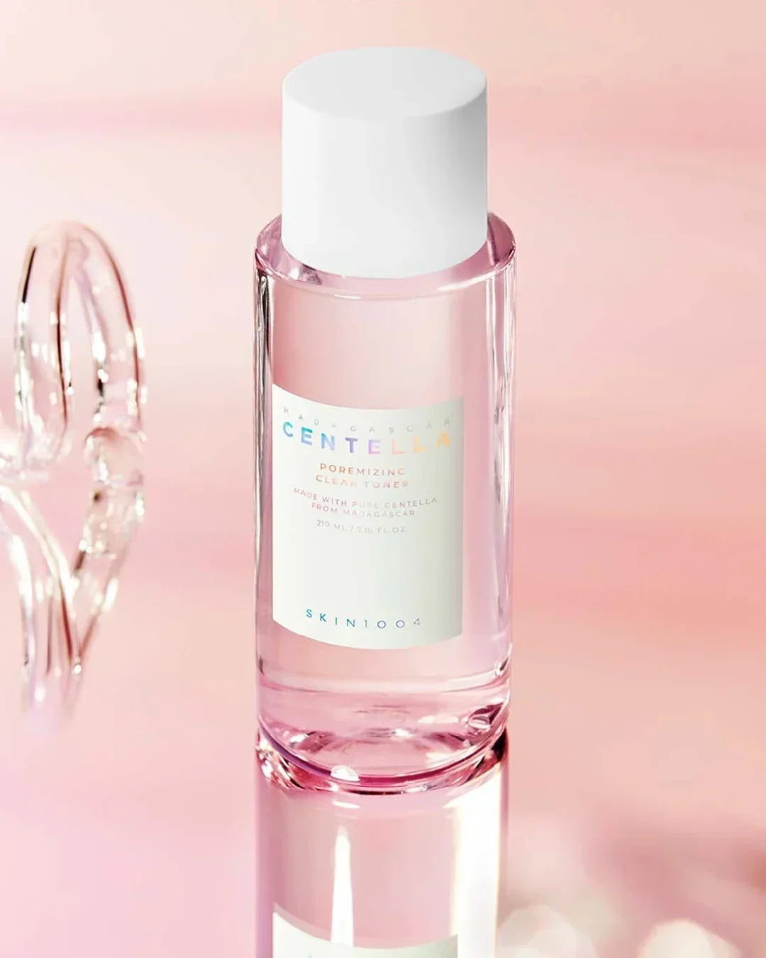Madagascar Centella Poremizing Clear Toner 210ml bottle with white cap on pink background