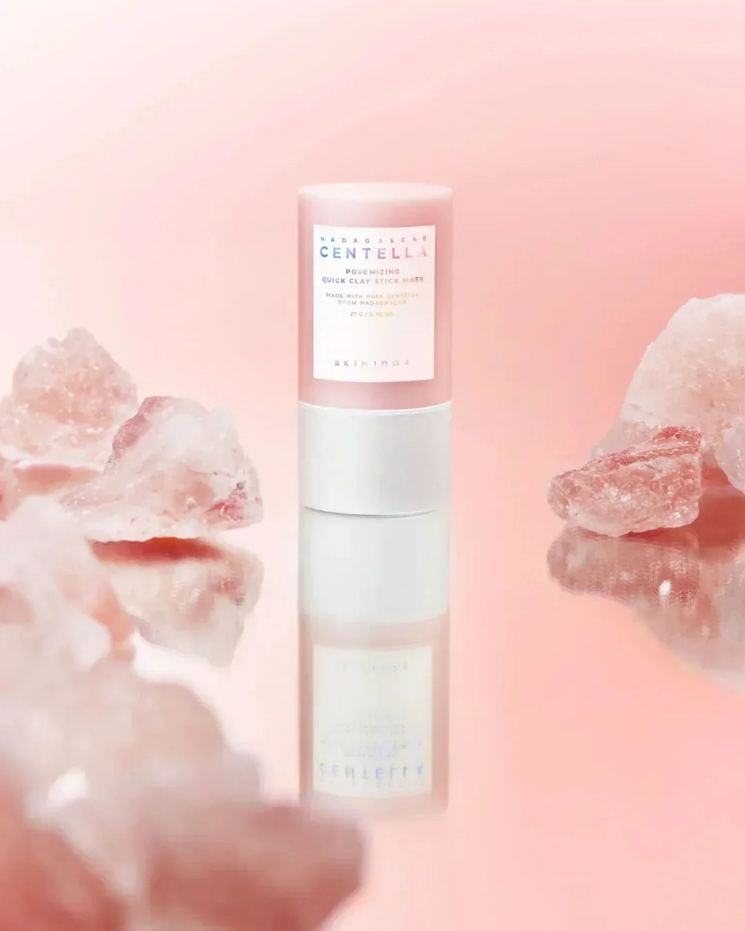 Madagascar Centella Poremizing Quick Clay Stick Mask by Skin1004 with pink crystals on a reflective surface