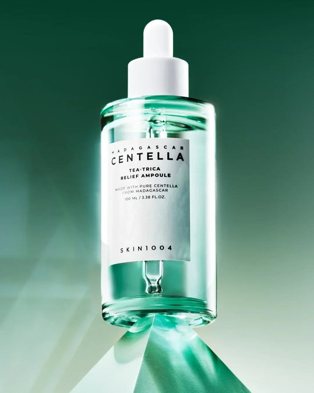 Skin1004 Madagascar Centella Tea-Trica Relief Ampoule 100ml bottle with dropper on green background
