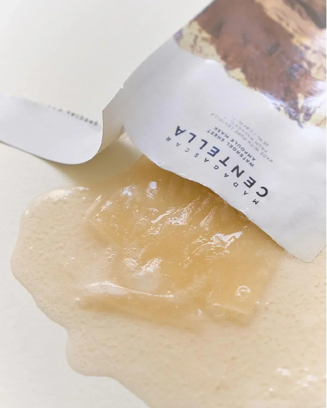 Madagascar Centella watergel sheet ampoule mask partially pulled out of white packaging with gel texture on surface