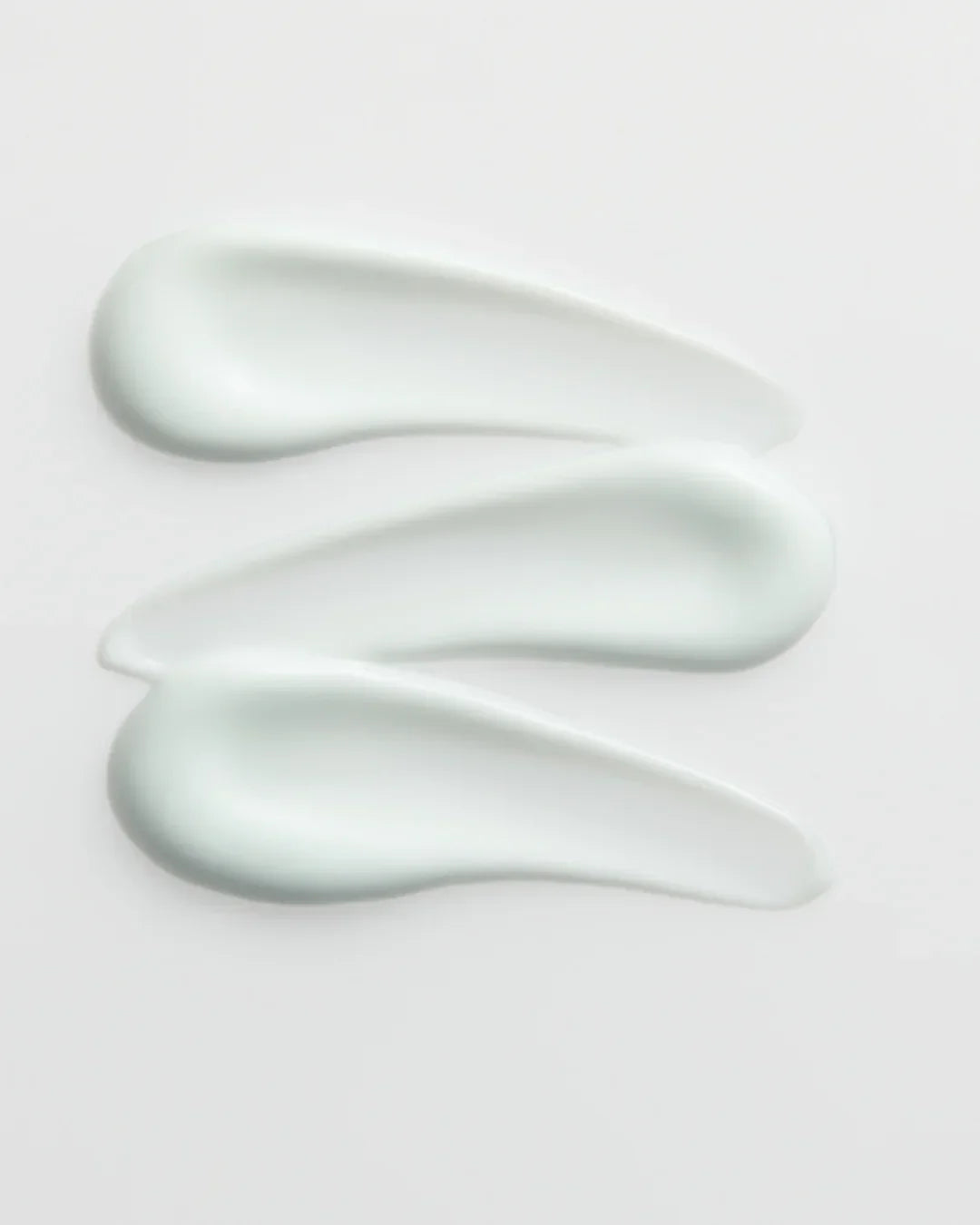 Three streaks of light blue Madagascar Hyalu-Cica Moisture Cream texture on white background