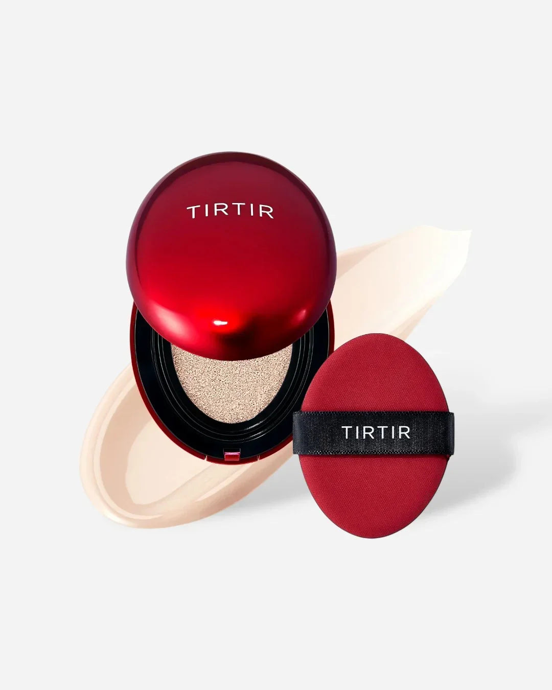 Red TIRTIR cushion compact with sponge applicator and beige foundation smear on white background