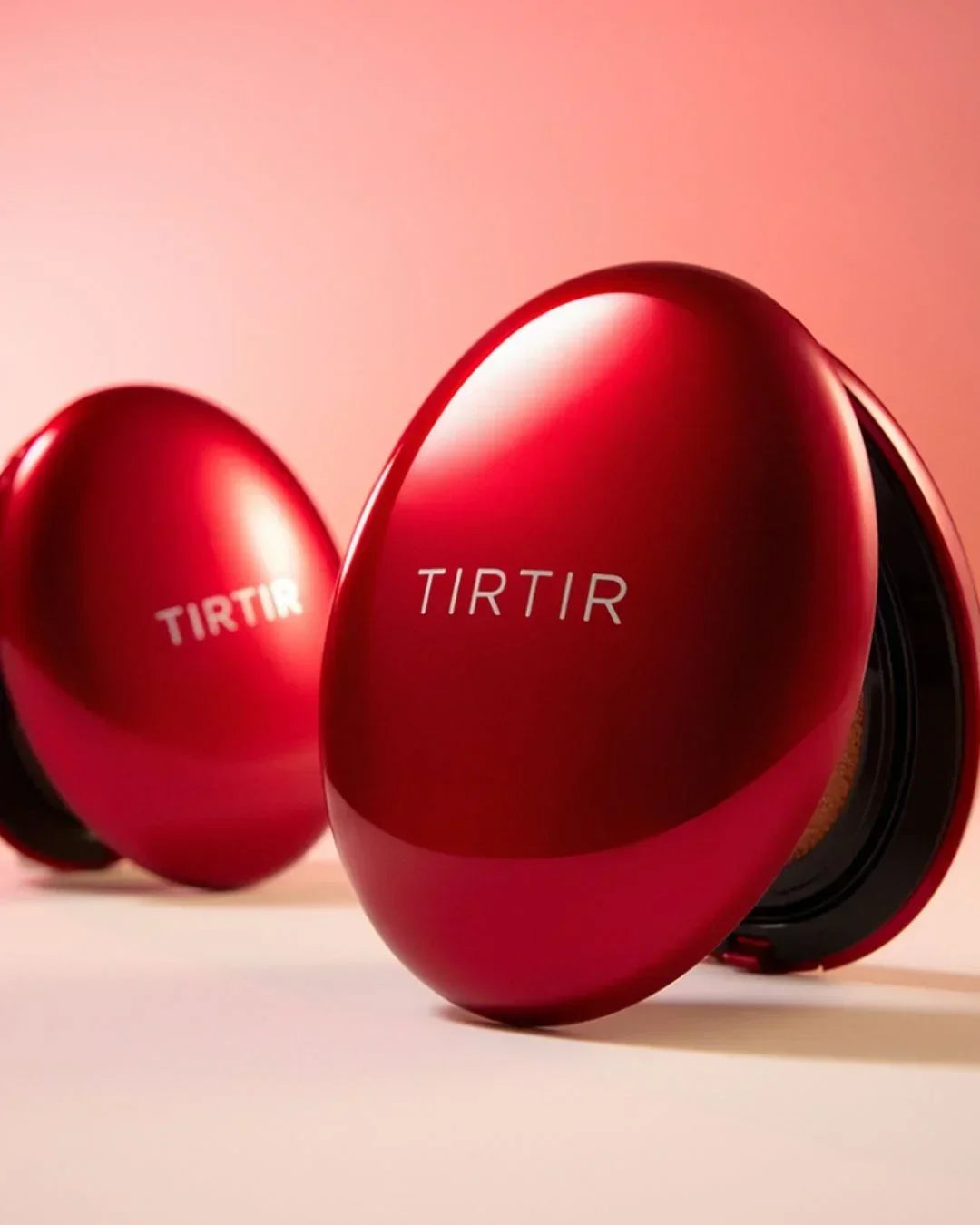 Red TIRTIR makeup compact cushions on soft pink background