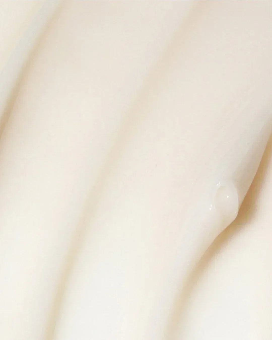 Close-up texture of smooth, creamy white mugwort calming cream