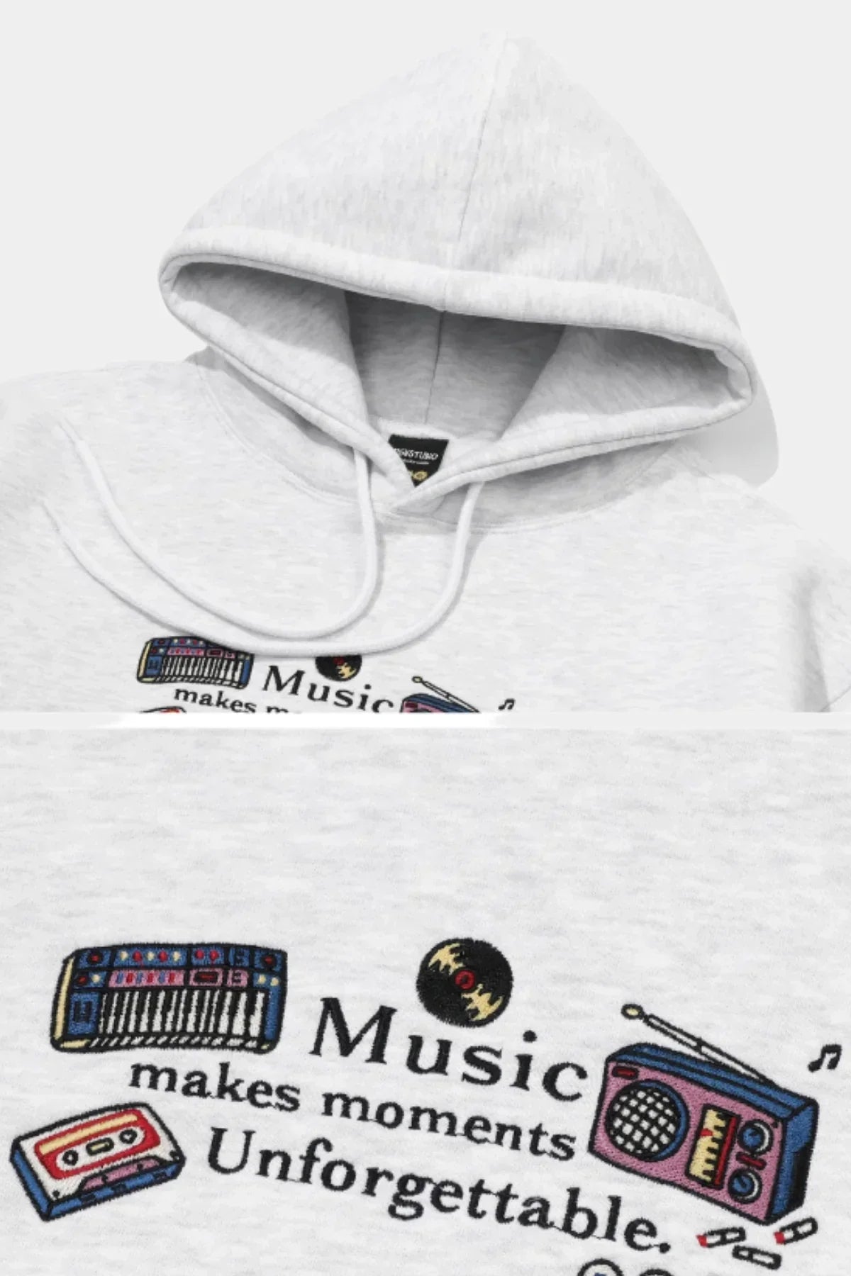 Melange white hoodie with embroidered music-themed design and text Music makes moments unforgettable