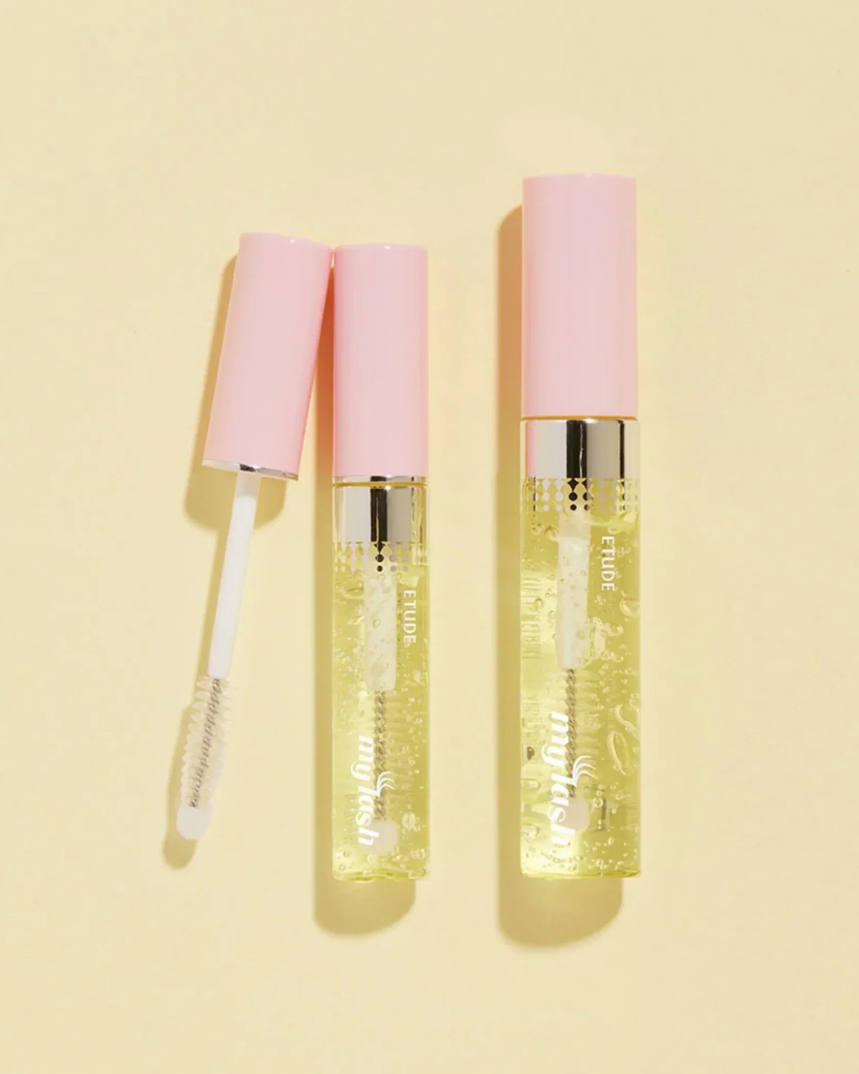 Two Etude My Lash serum tubes with pink caps on a light yellow background, one open with applicator visible