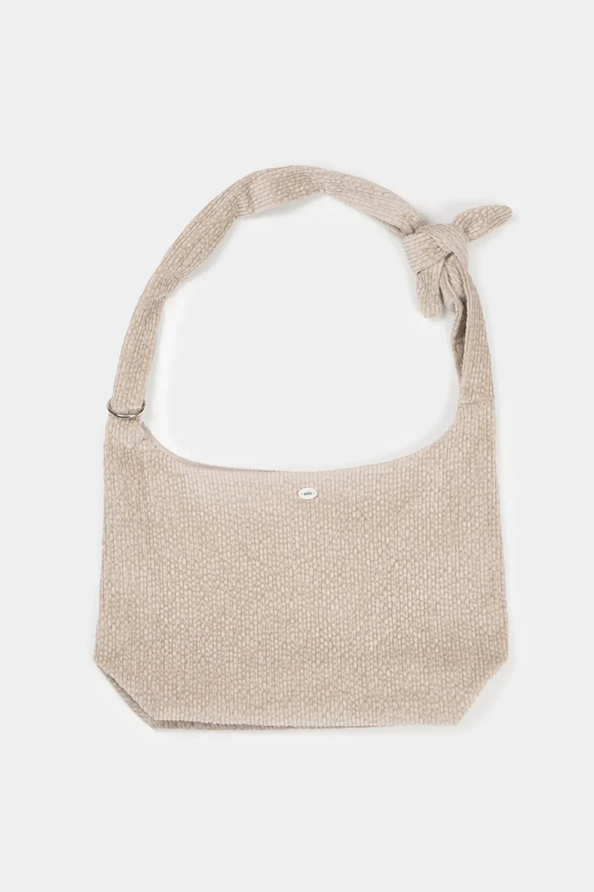 Beige natural fabric shoulder bag with textured pattern and knot detail on strap