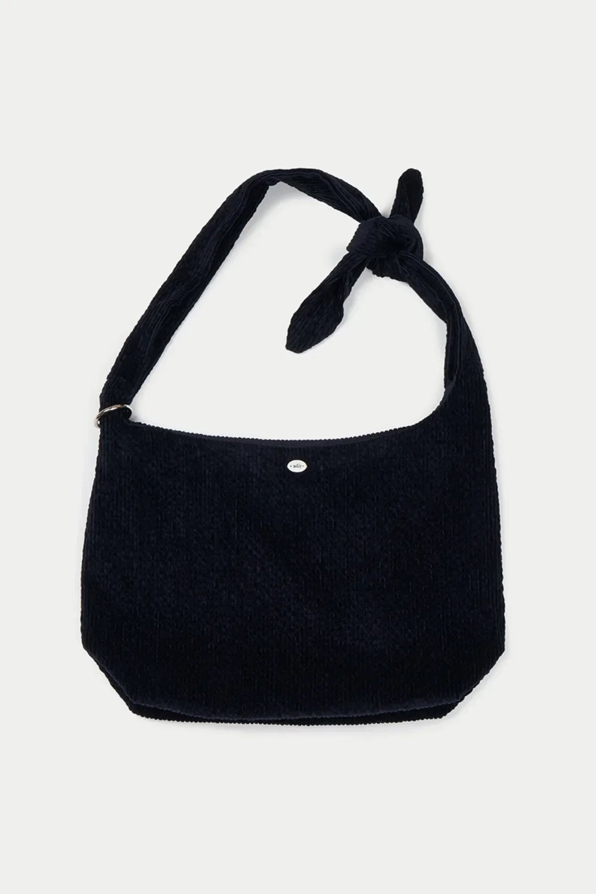 Dark navy blue textured fabric shoulder bag with knotted strap detail on white background
