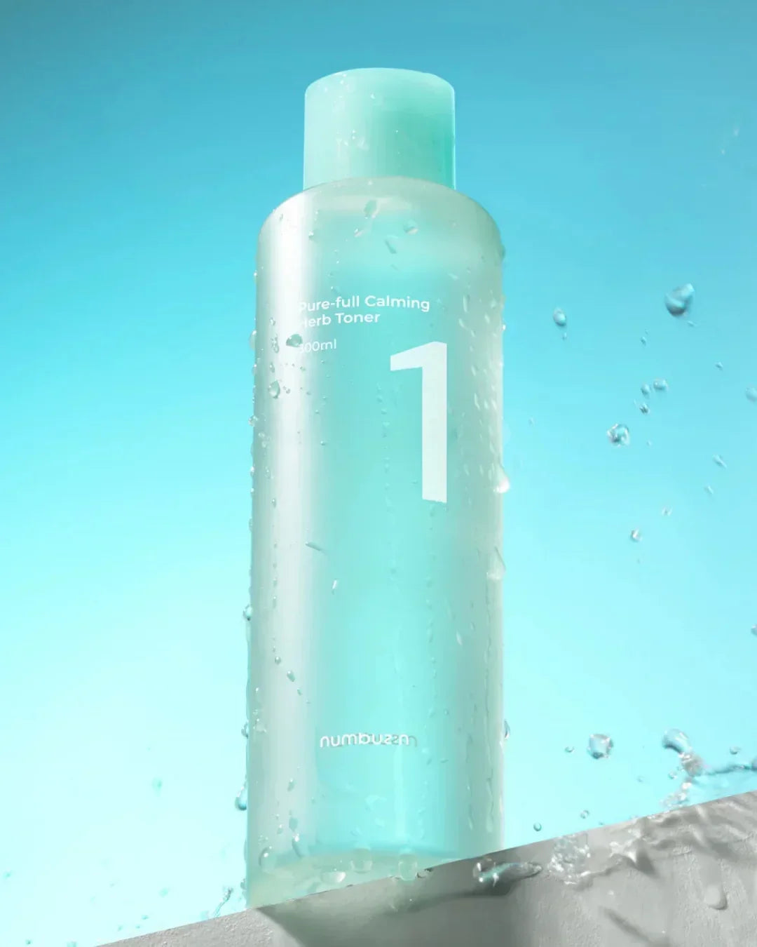 Numbuzin Pure-full Calming Herb Toner 300ml bottle with water droplets on blue background