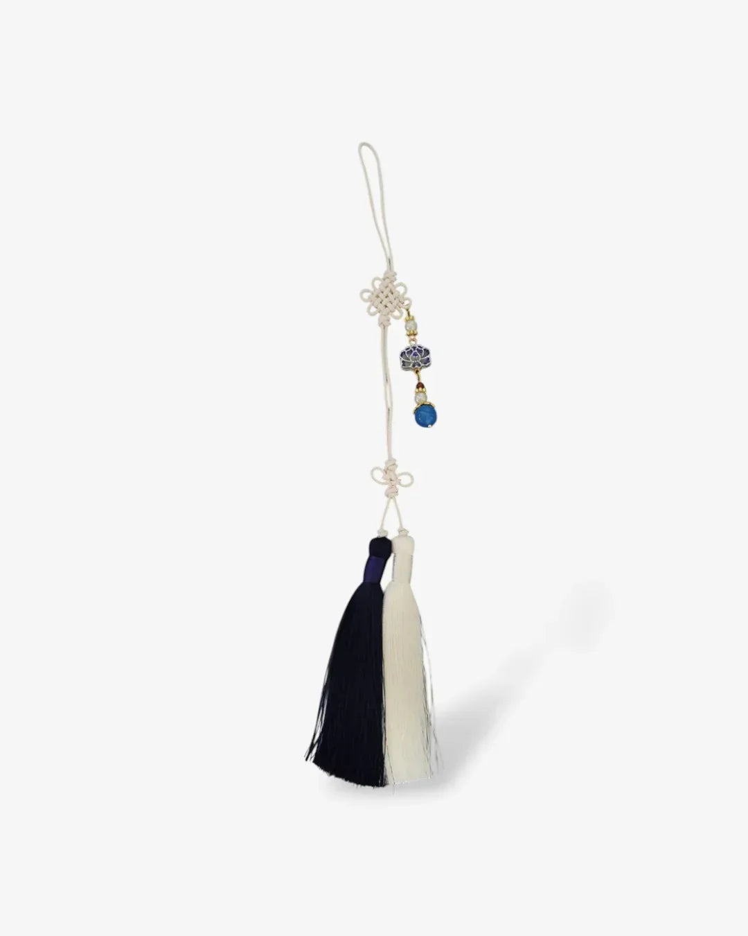 Blue and white traditional Korean norigae tassel with floral charm on white background