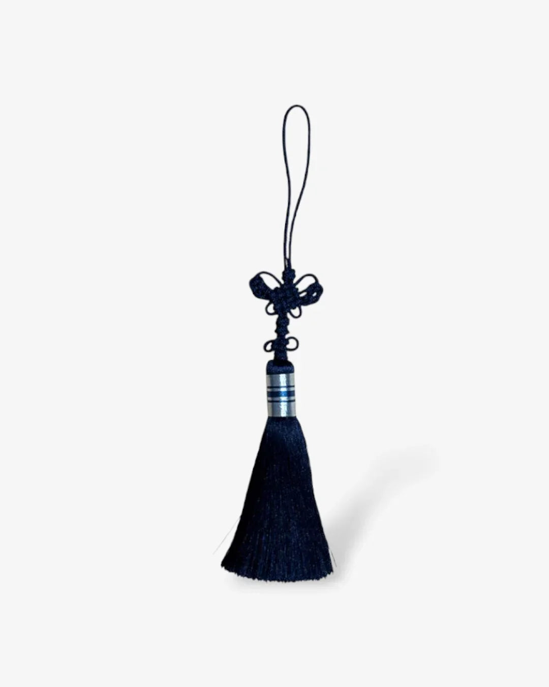 Navy blue butterfly knot norigae tassel with silver band detail on white background