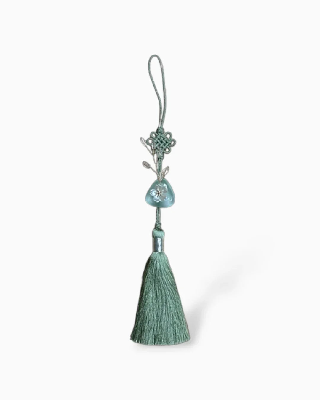 Light green traditional Korean norigae tassel accessory with floral charm and knot design