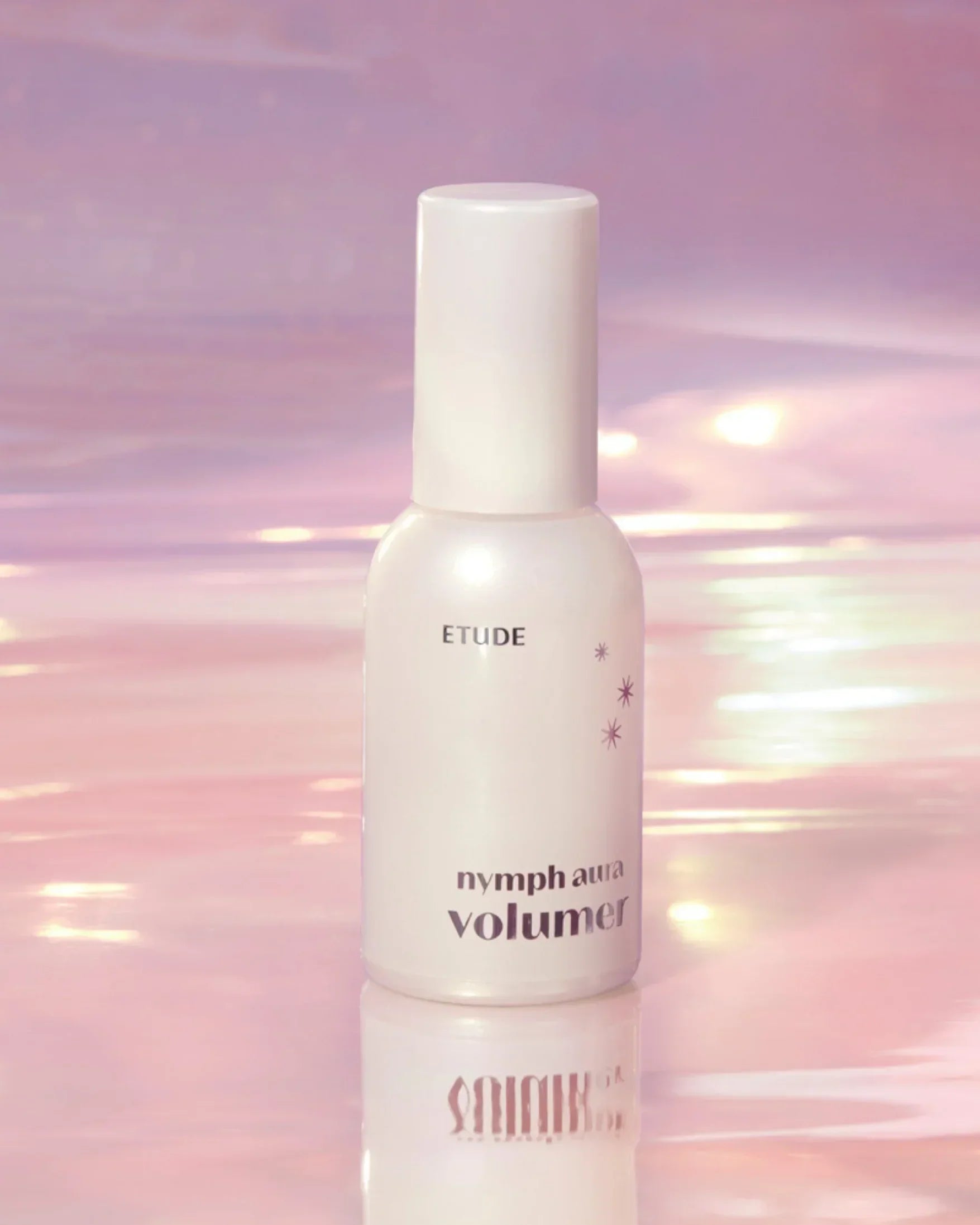Etude Nymph Aura Volumer cosmetic bottle on reflective pink and purple surface