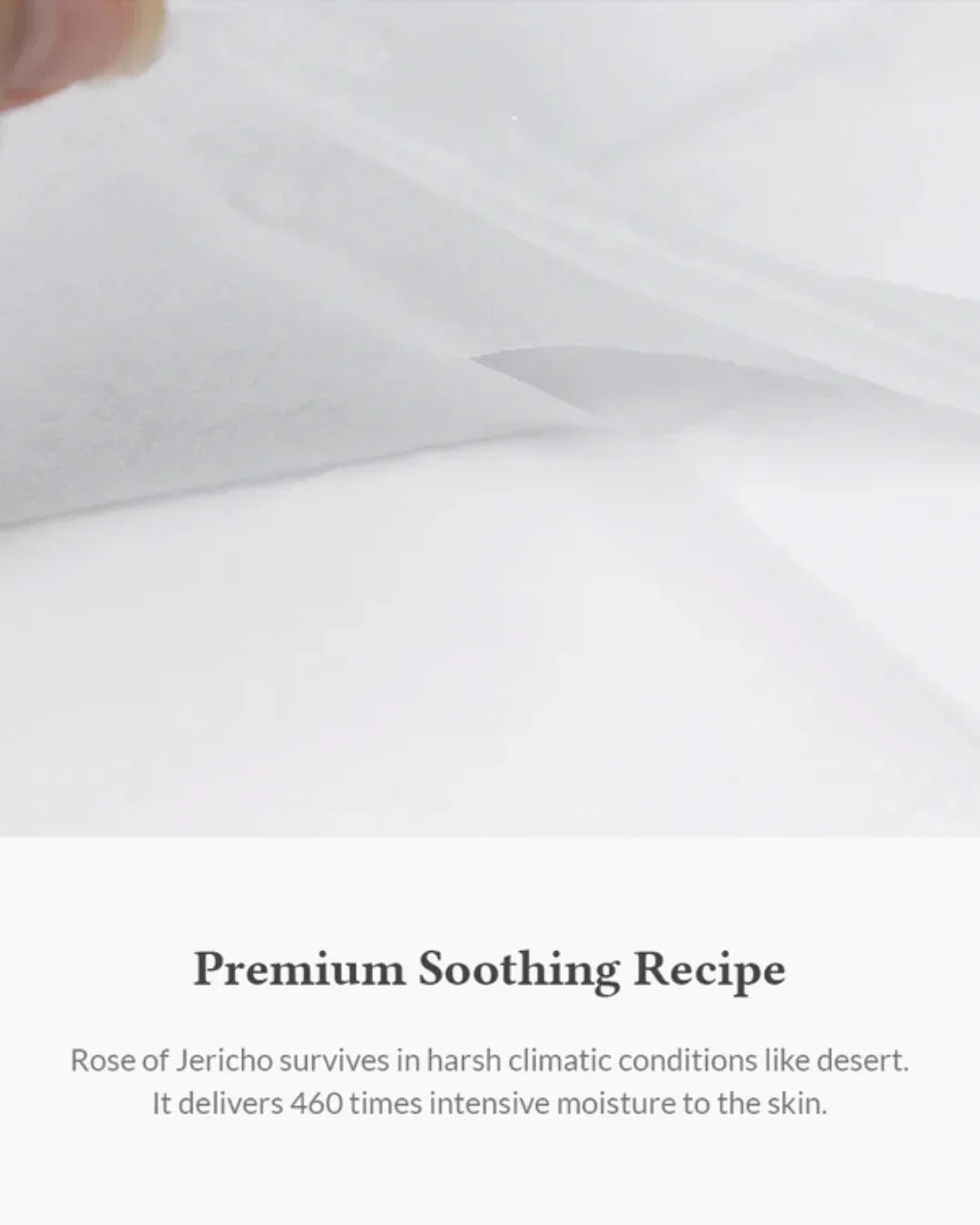 Close-up of a hand lifting a translucent sheet mask with text about Rose of Jericho soothing skin formula