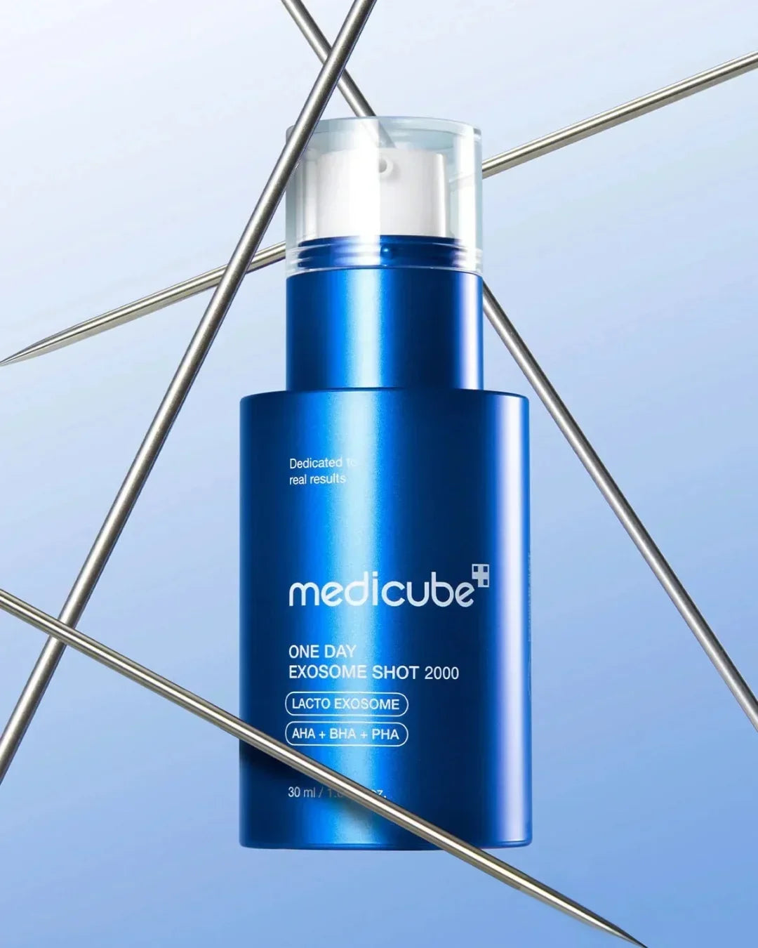 Medicube One Day Exosome Shot 2000 skincare serum bottle with metallic needles on blue background