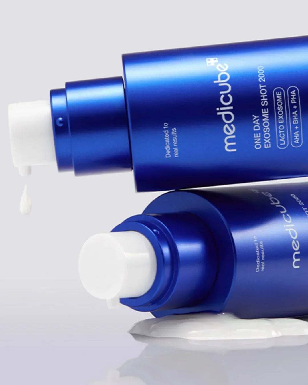 Blue Medicube One Day Exosome Shot skincare bottles with white pump dispenser and serum drop