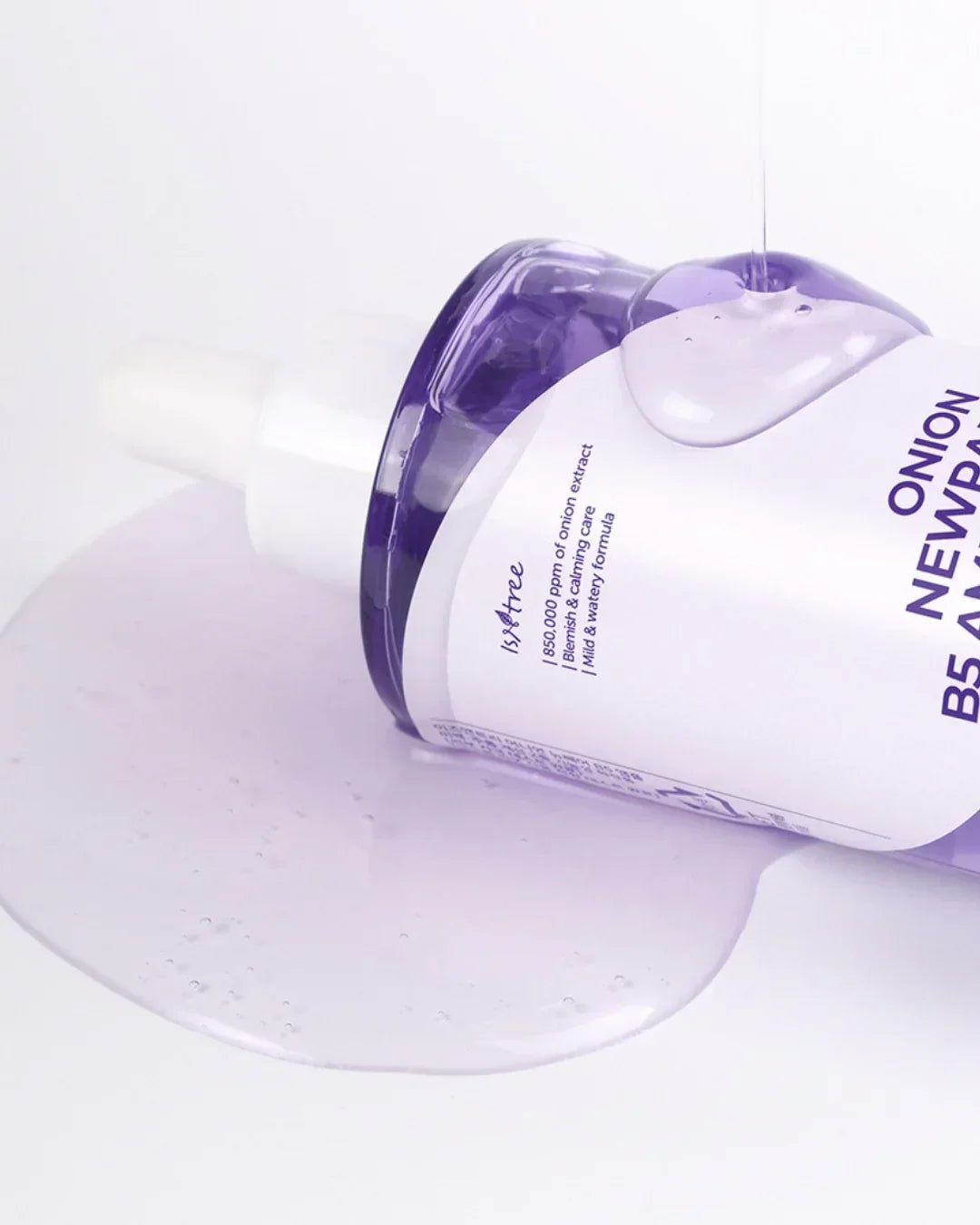 Isntree Onion Newpair B5 Ampoule 50ml with clear serum spilled on white surface