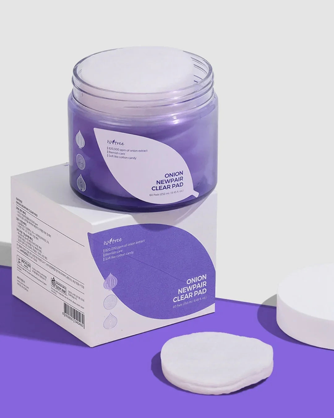 Isntree Onion Newpair Clear Pad jar and box on purple surface with cotton pads