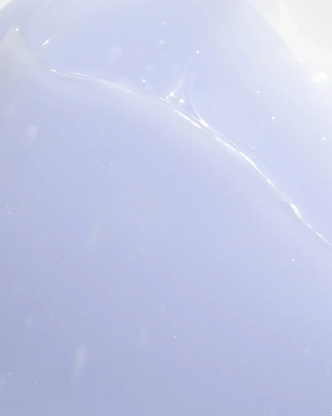 Close-up of light purple gel cream texture with smooth, glossy surface