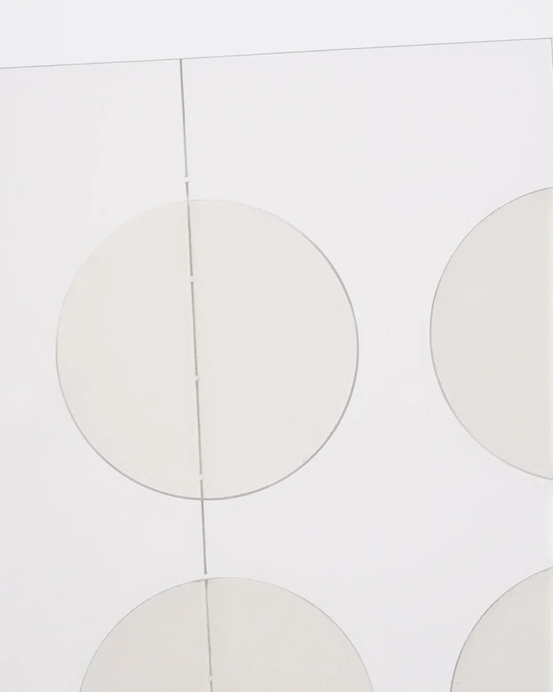 Transparent circular adhesive spot patches on a white sheet for skincare use
