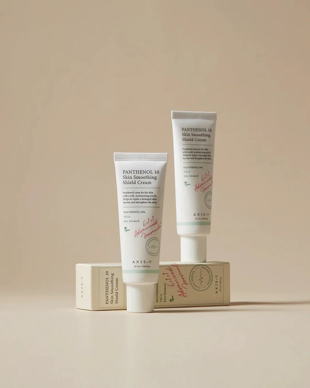 Axis-Y Panthenol 10 Skin Smoothing Shield Cream tubes and packaging on beige background