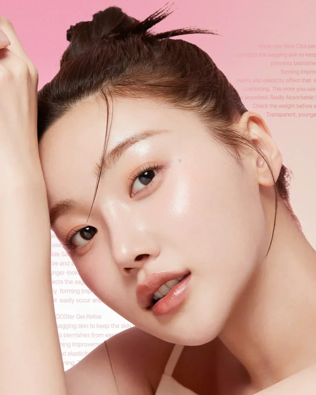 Close-up of woman with glowing skin and natural makeup against soft pink background