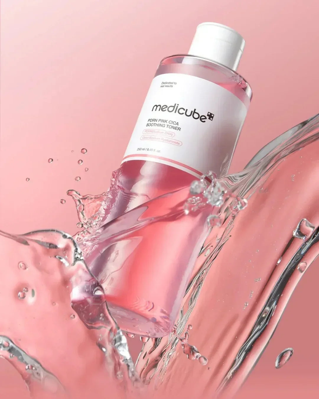 Mediclube PDRN Pink Cica Soothing Toner 250ml bottle with water splash on pink background