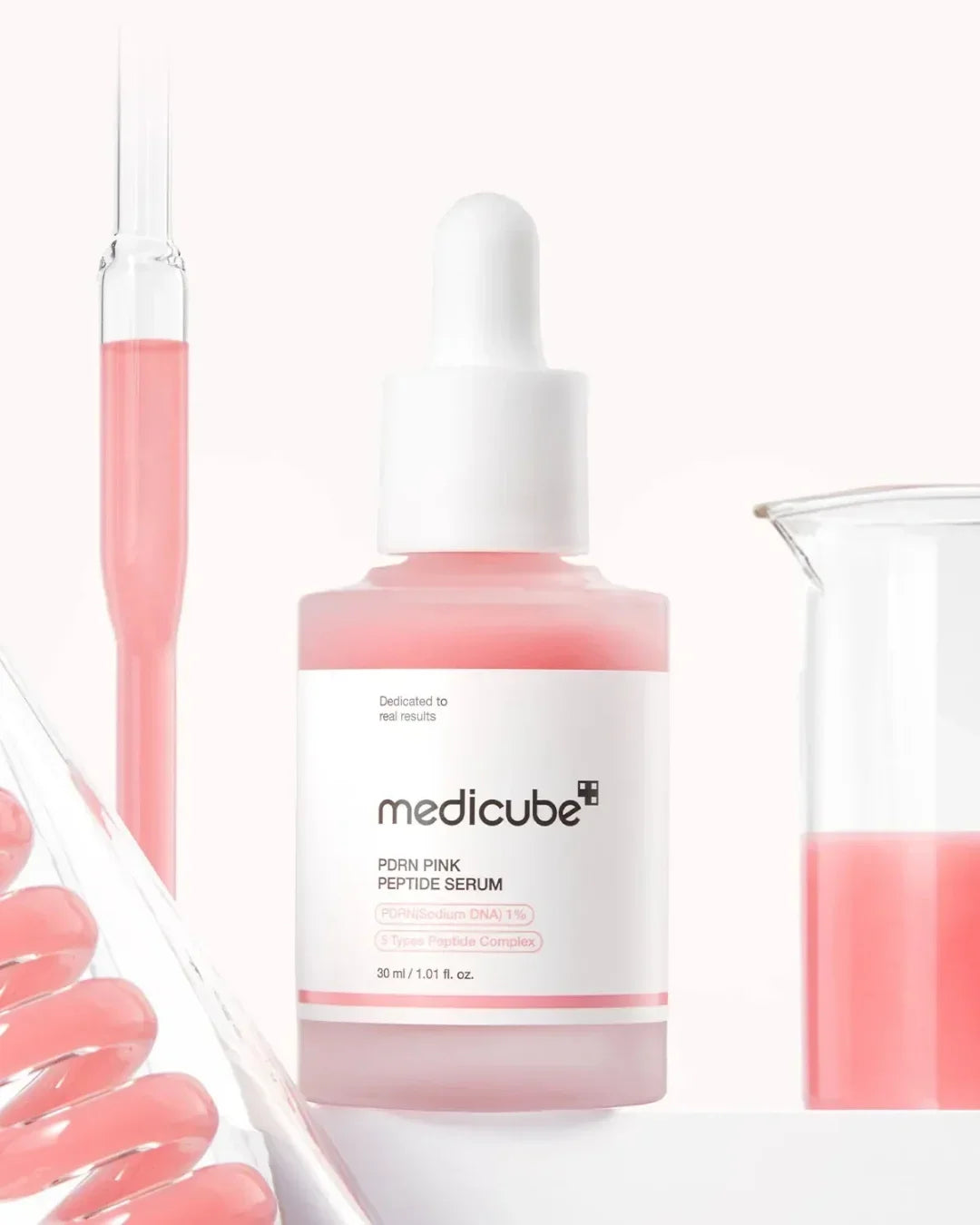 Medicube PDRN Pink Peptide Serum bottle with dropper and pink liquid in lab glassware