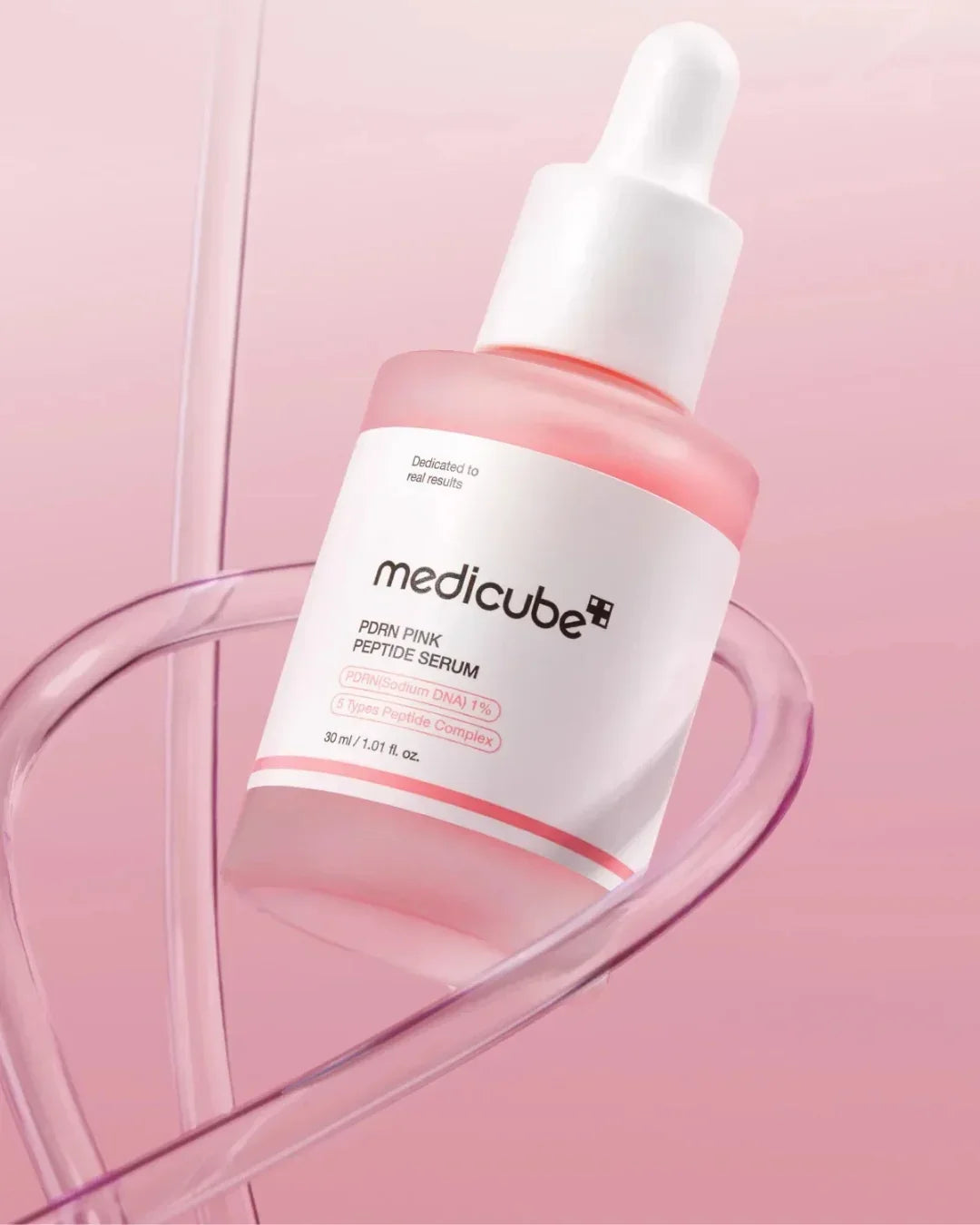 Medicube PDRN Pink Peptide Serum 30ml with white dropper on pink background