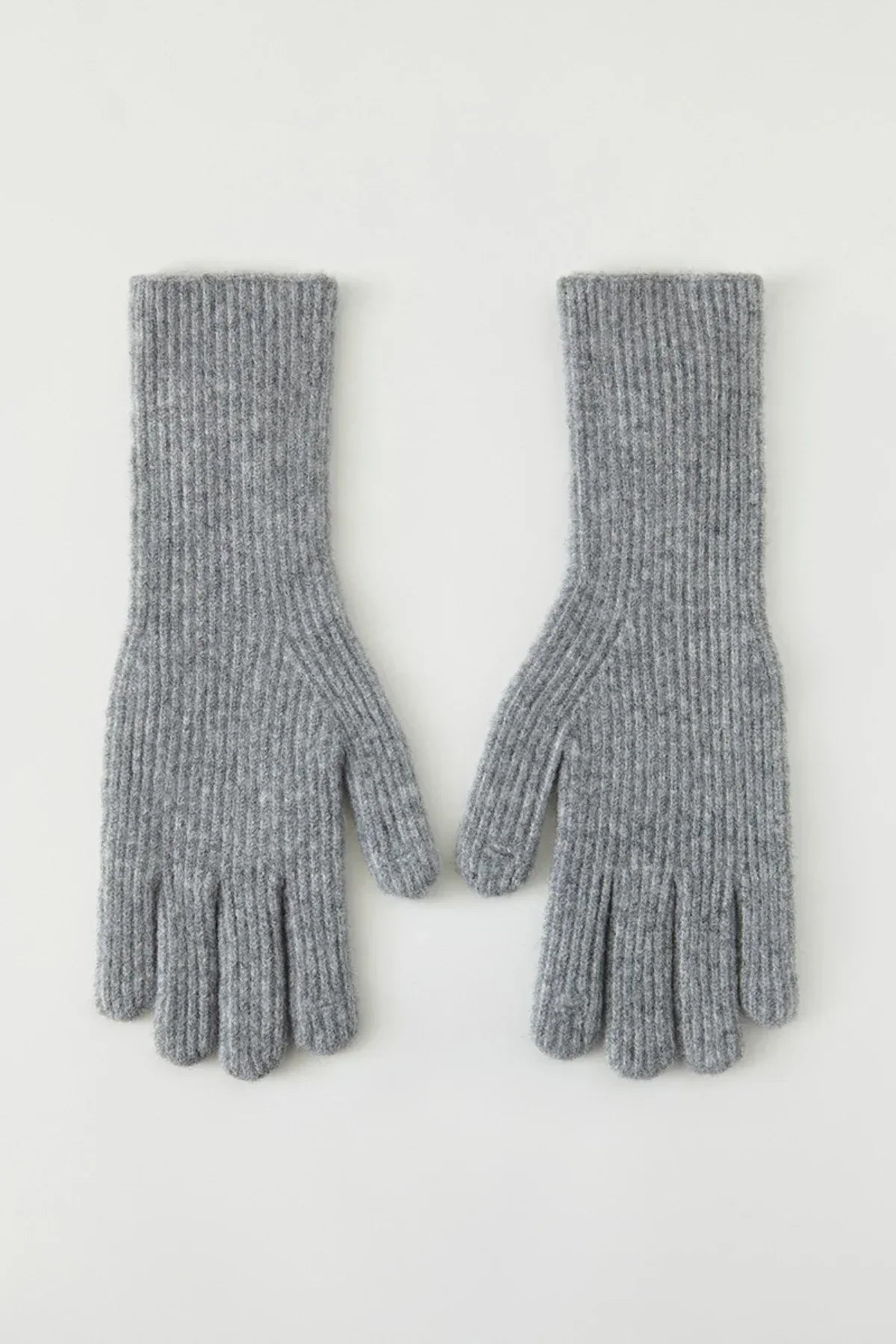 Pair of gray ribbed knit wool gloves laid flat on white background