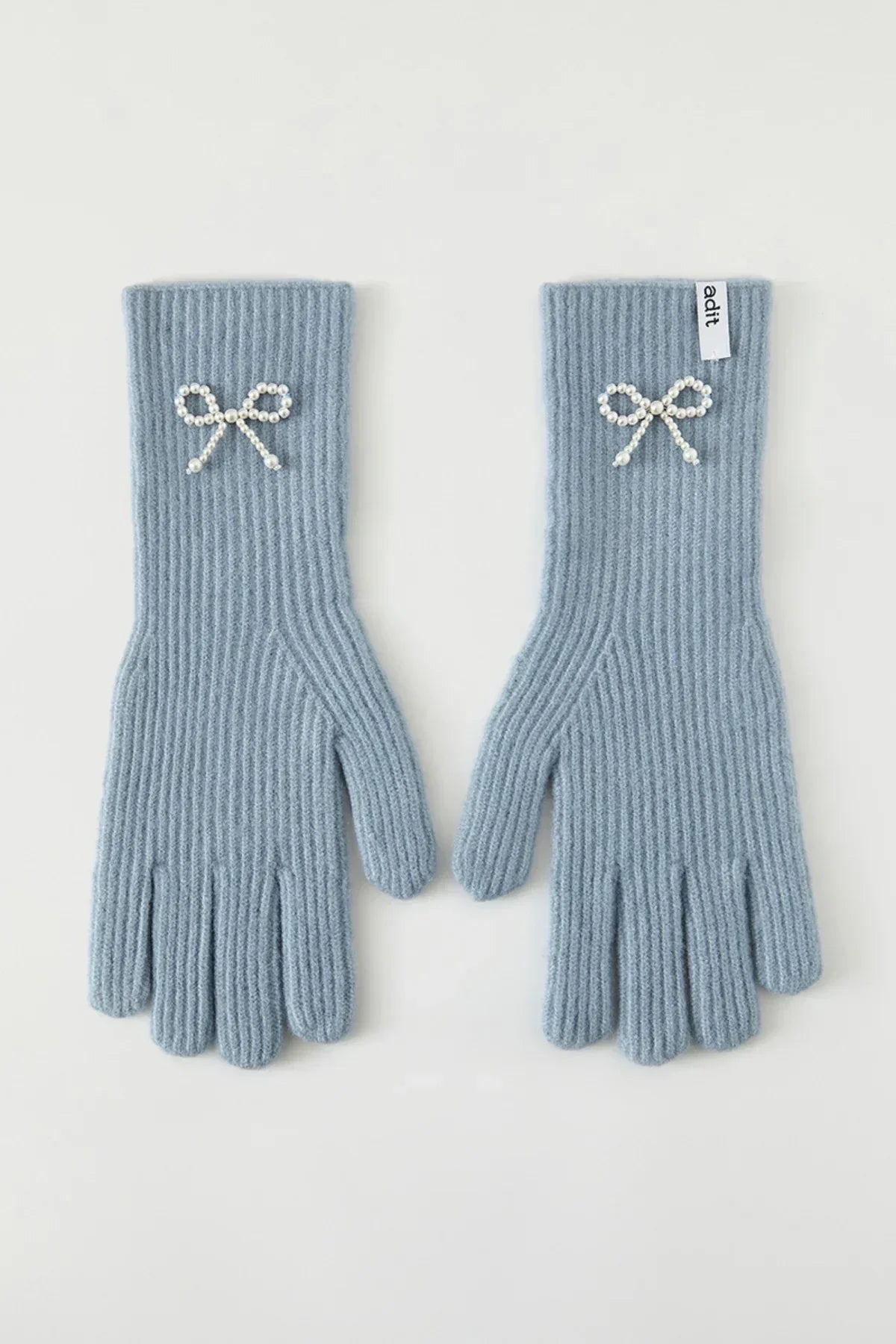 Pair of light blue ribbed knit gloves with pearl bow embellishments on each wrist