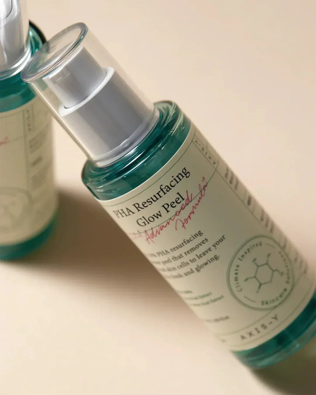 Bottle of PHA Resurfacing Glow Peel with advanced formula label on beige background