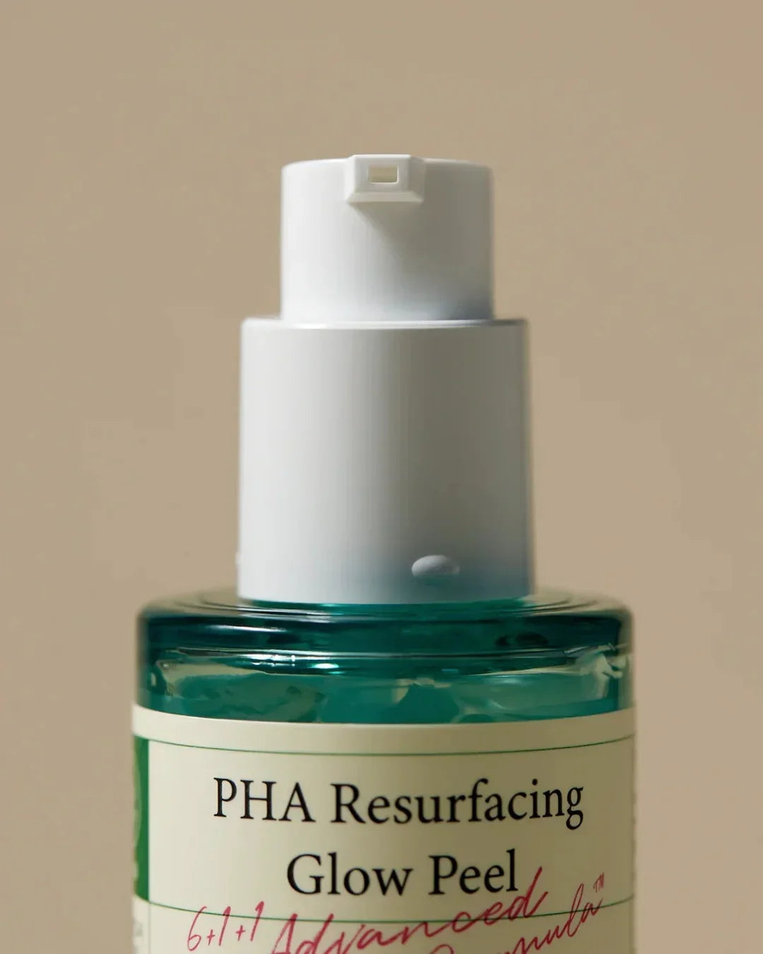 Close-up of green PHA Resurfacing Glow Peel serum bottle with white pump against beige background
