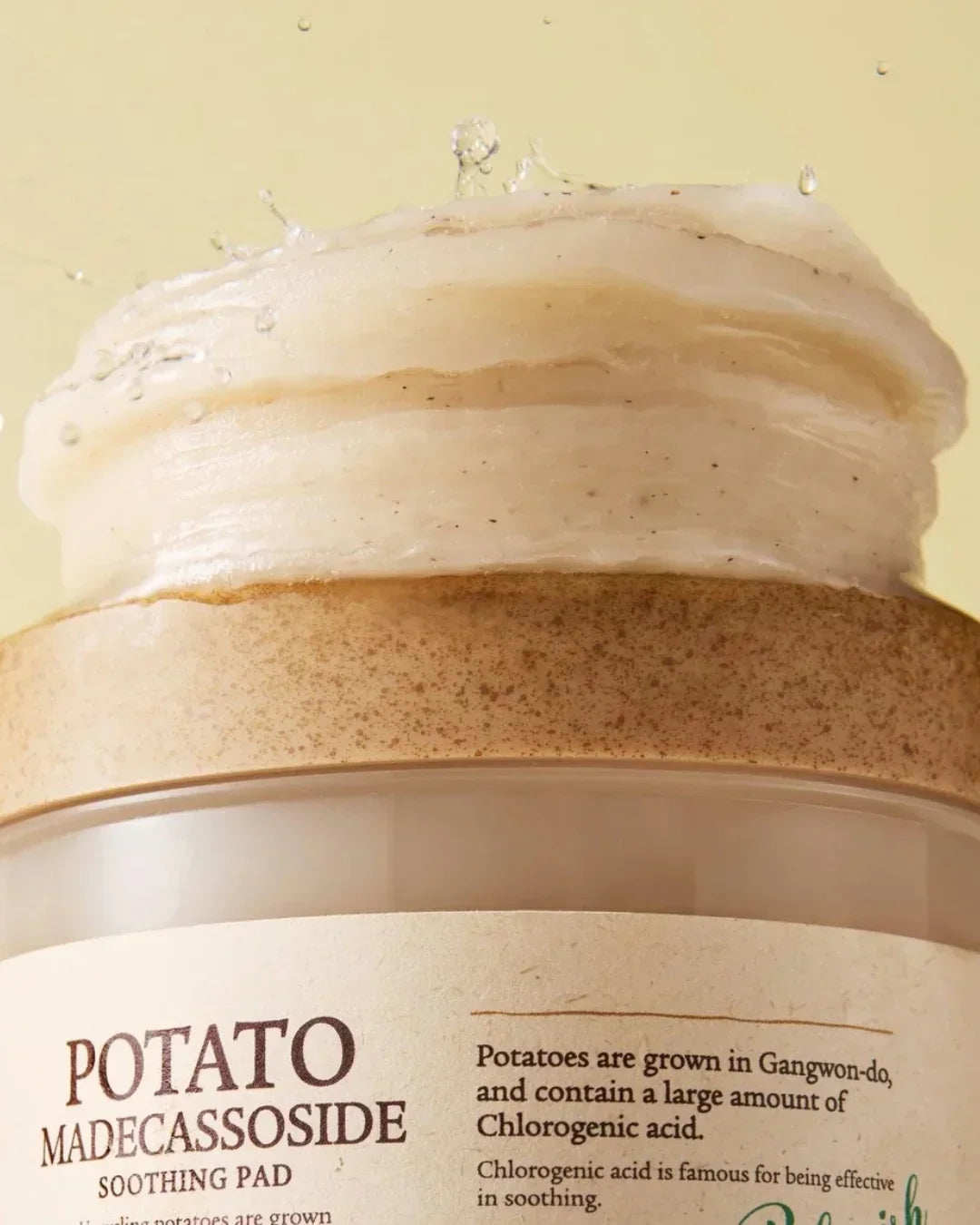 Close-up of Potato Madecassoside Soothing Pad with textured cream and water droplets