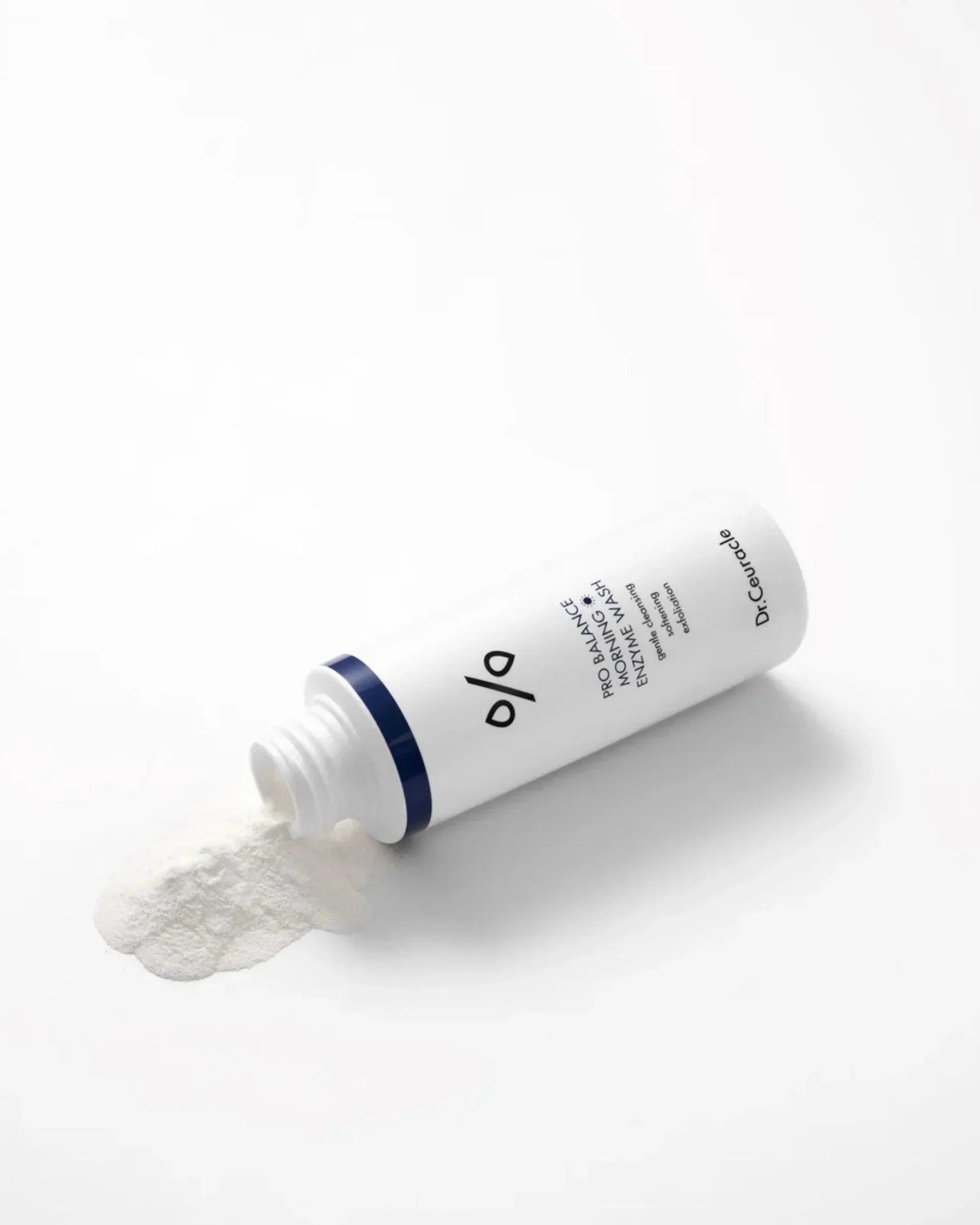 Dr. Ceuracle Pro Balance Morning Enzyme Wash powder spilled from white bottle on white background