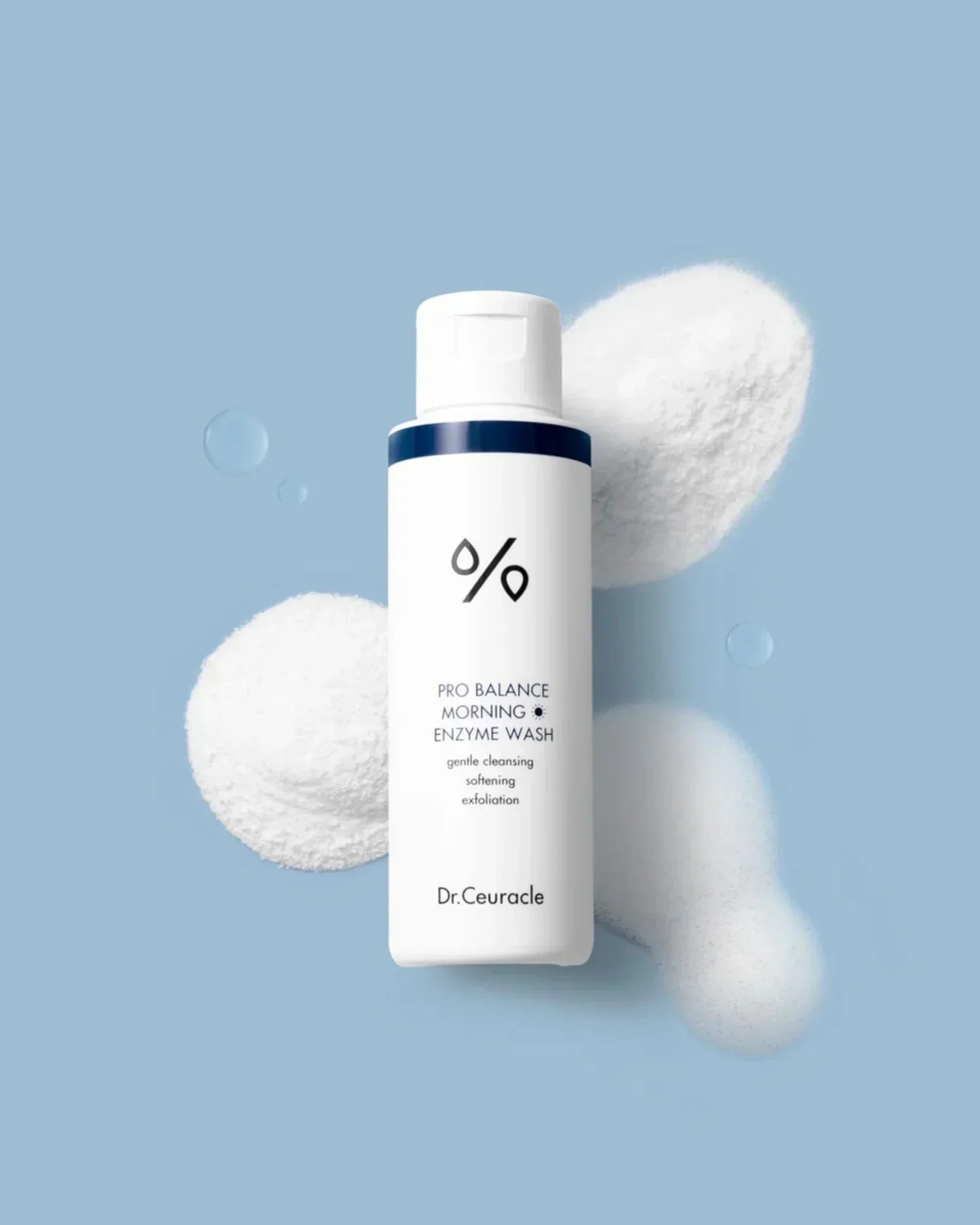 Dr.Ceuracle Pro Balance Morning Enzyme Wash bottle on blue background with foam and powder texture