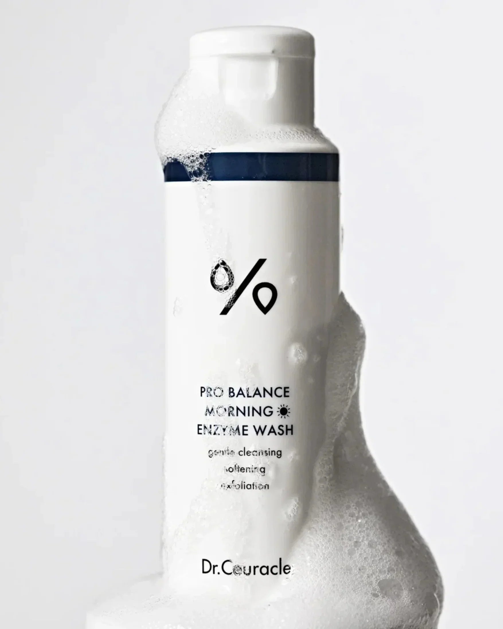 Dr. Couracle Pro Balance Morning Enzyme Wash bottle with foamy cleanser on white background