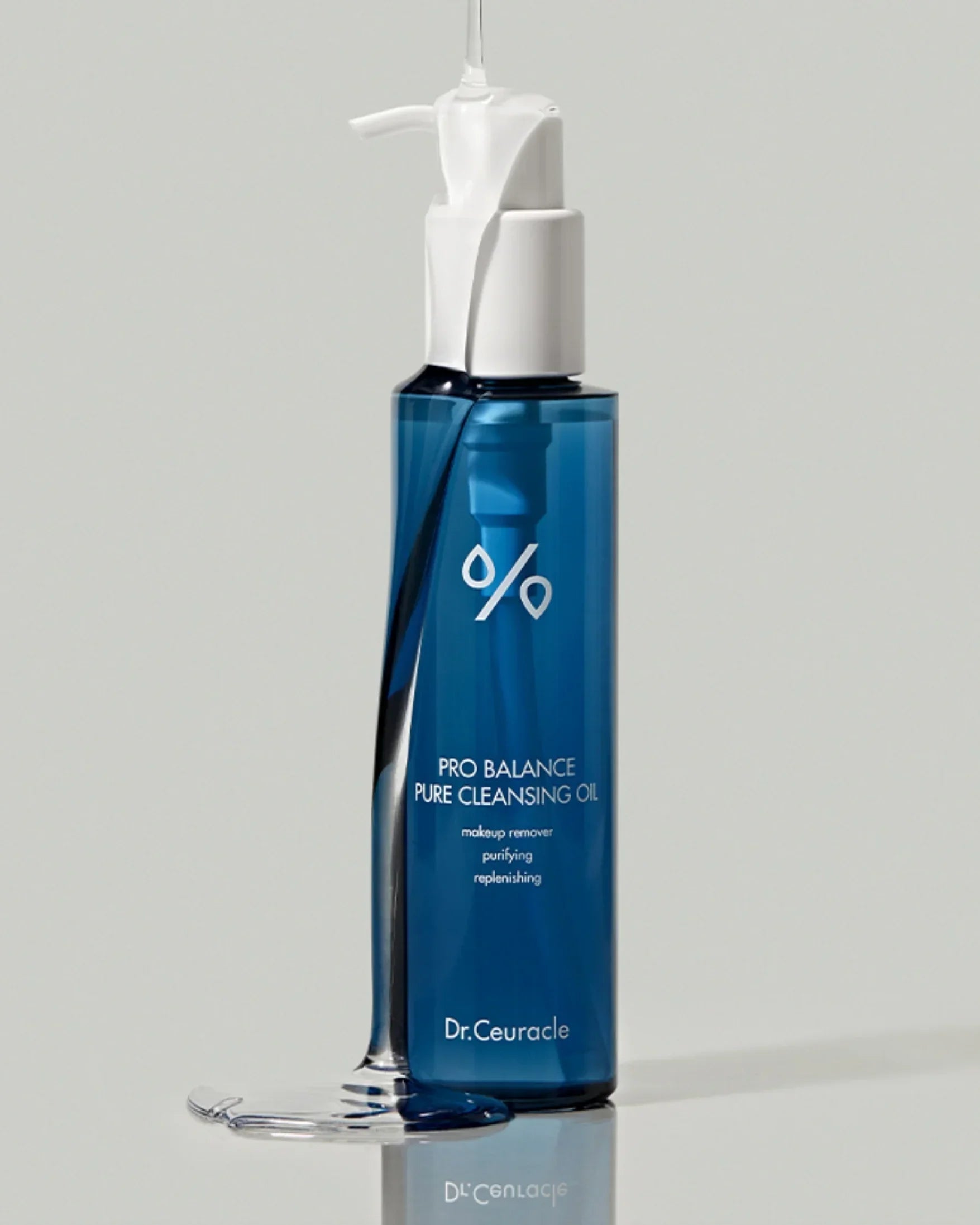 Blue bottle of Dr.Ceuracle Pro Balance Pure Cleansing Oil with white pump and clear oil dripping