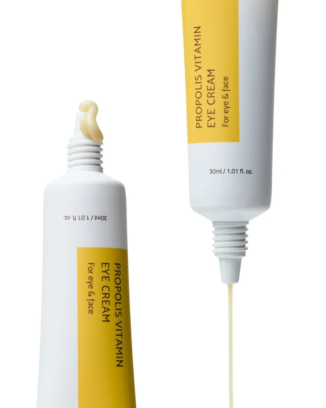 Propolis vitamin eye cream tube with yellow label, cream dollop on nozzle, white background