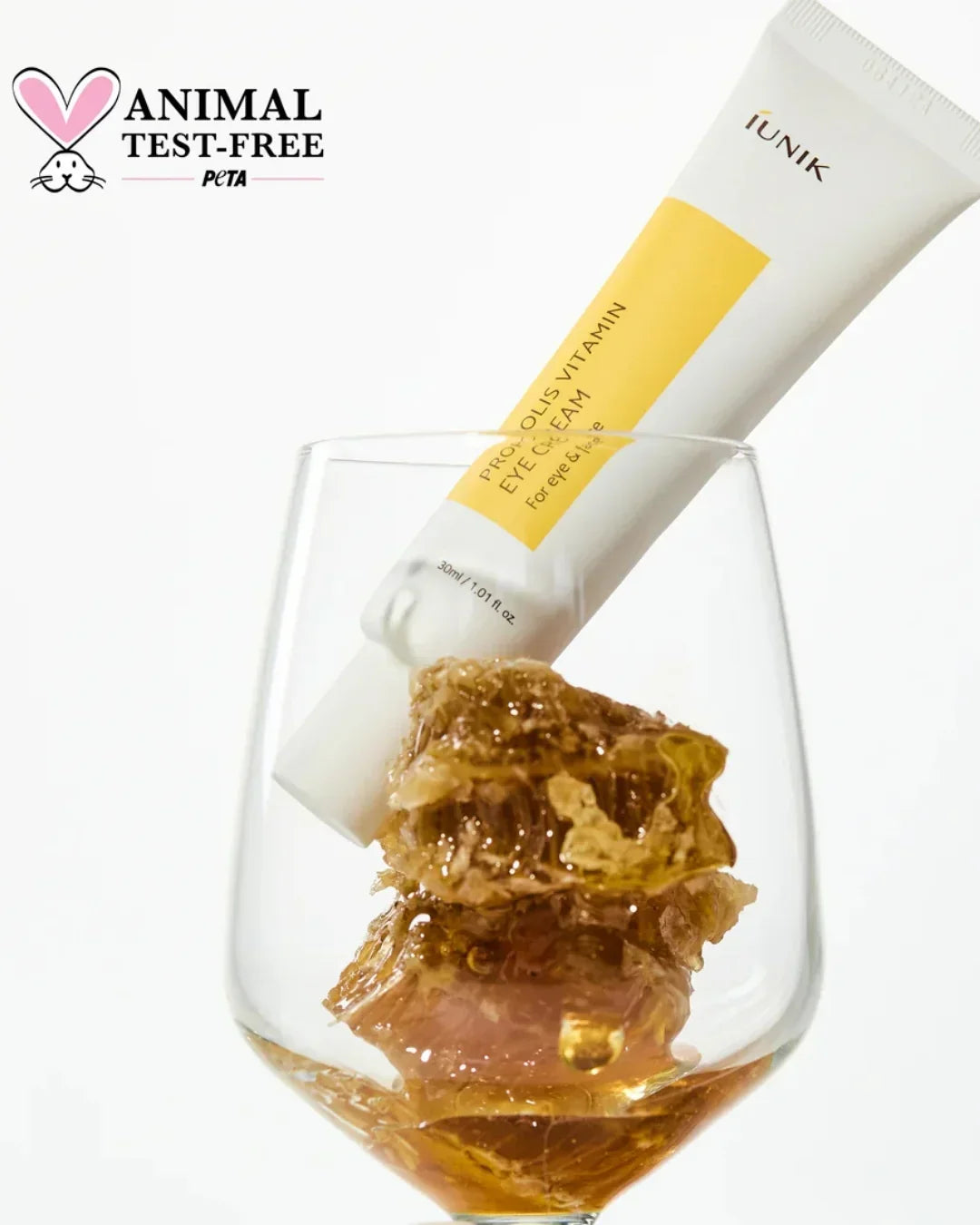 iUNIK Propolis Vitamin Eye Cream tube in glass with propolis honeycomb, animal test-free logo