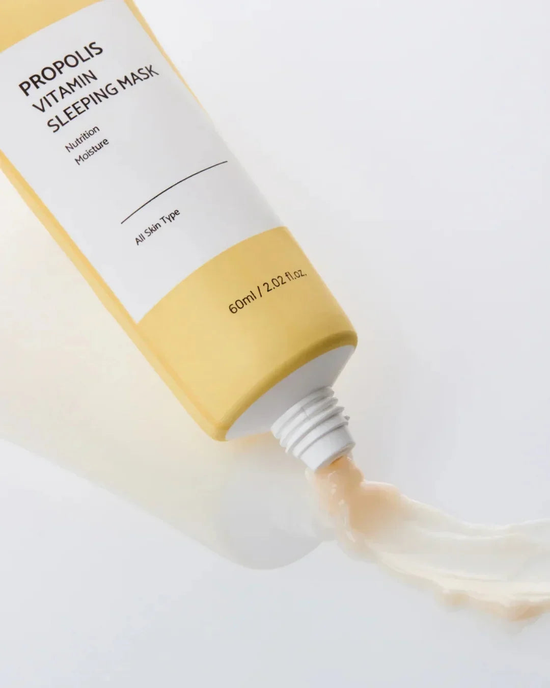 Propolis vitamin sleeping mask tube dispensing cream on white surface, 60ml skincare product