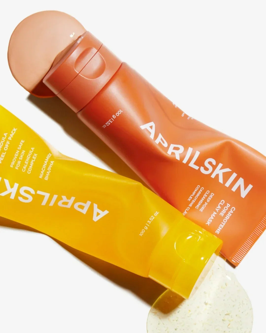 April Skin calendula peel-off pack and carotene pore clay mask tubes with product spilled