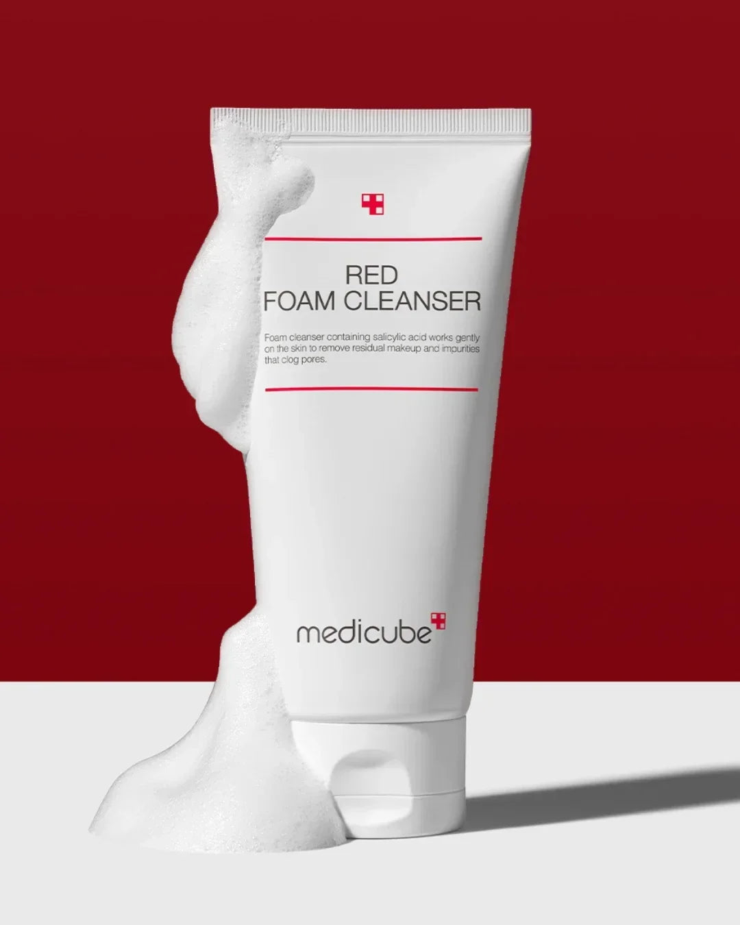 Medicube Red Foam Cleanser tube with white foam against a red and white background