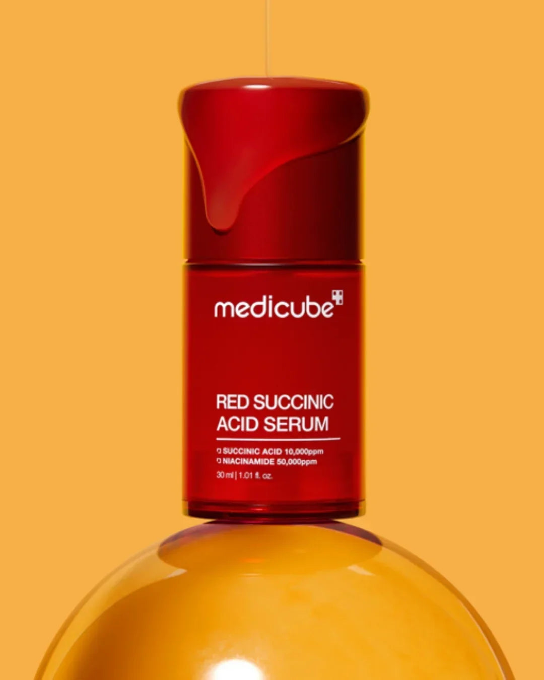 Medicube Red Succinic Acid Serum 30ml bottle with serum texture on orange background
