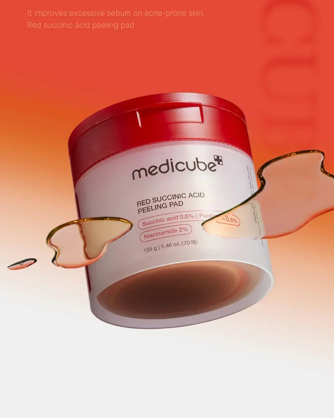 Medicube Red Succinic Acid Peeling Pad container with red lid and liquid droplets against orange gradient background